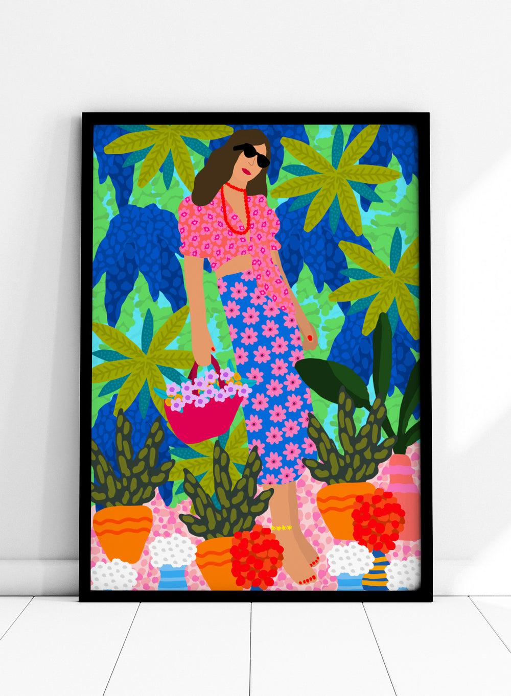 Woman in a floral dress holding a basket of flowers amidst colorful plants. Walking Between Gardens by Rafaela Mascaro fine art print poster featuring woman carrying flowers in lush tropical garden, modern contemporary botanical wall art.