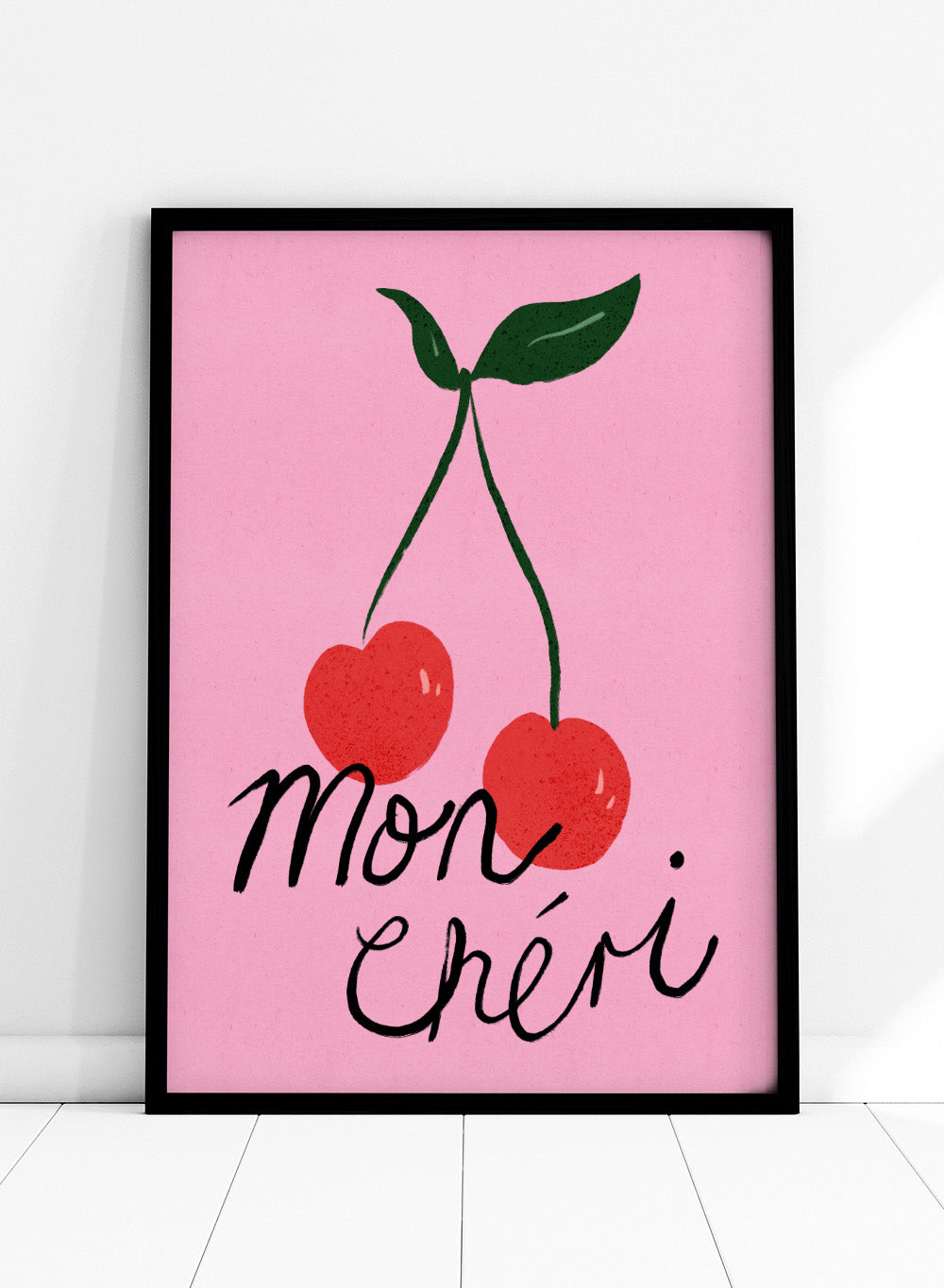 Two red cherries with green stems on a pink background and 'mon chéri' text. Mon Chéri by Dirkie Nell is a cherry typography art print featuring bold red fruit and playful lettering. A colorful love-inspired wall poster.