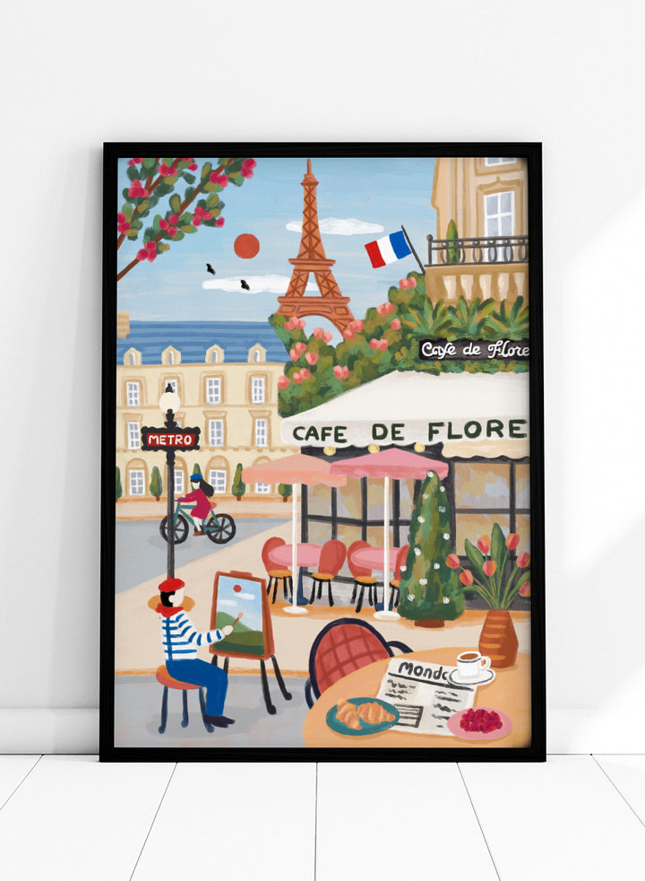 A colorful illustrated Paris street scene with the Eiffel Tower, a cafe exterior labeled Cafe de Flore, a cyclist, a seated painter, flowers, and a French flag. Shop Paris Cafe Life by Nidhi Kachhadiya, a colorful Paris wall art print inspired by French café culture, the Eiffel Tower, and charming European city life.