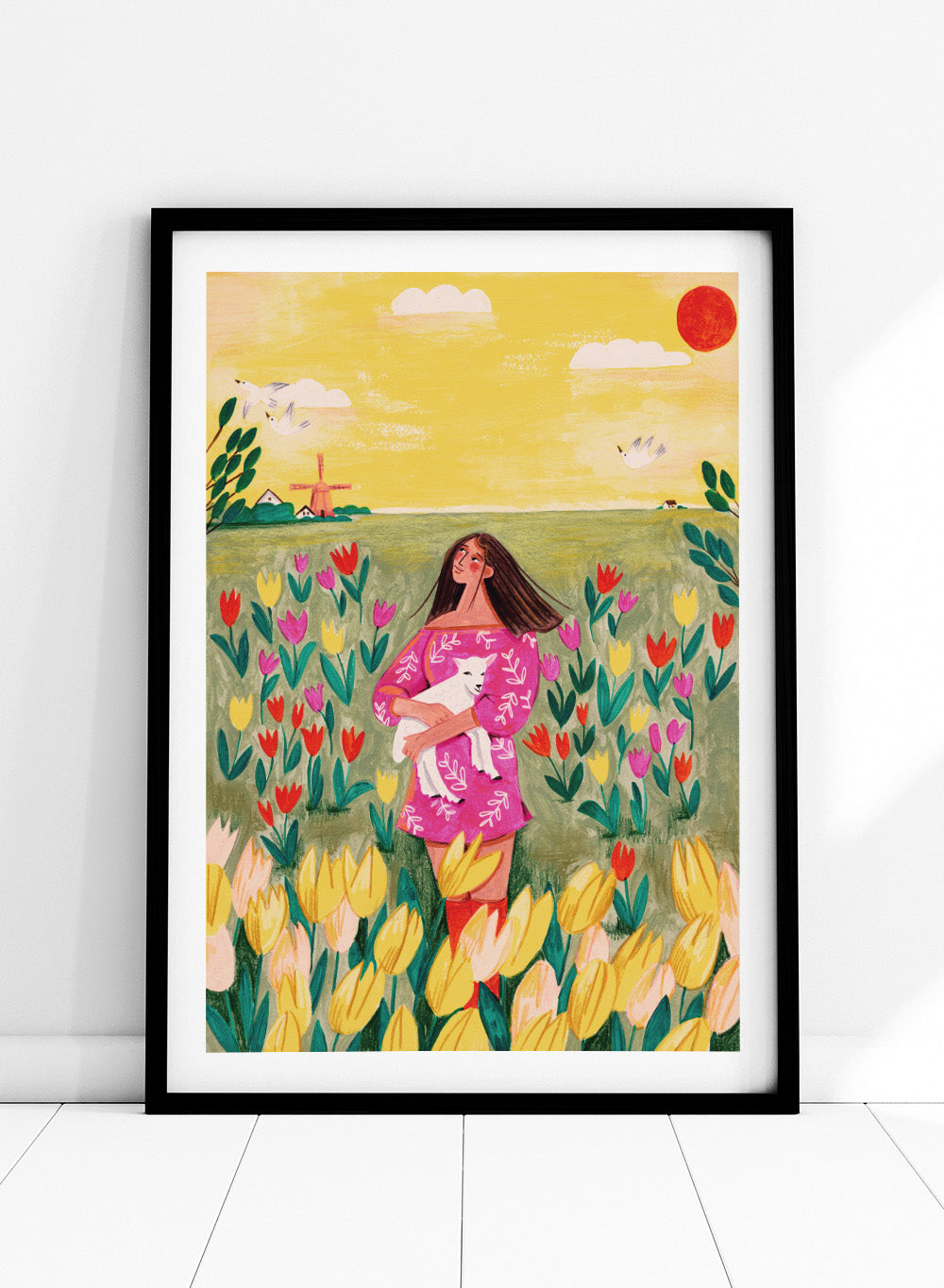 Woman holding a lamb in a field of flowers with a yellow sky and red sun. Woman Lamb Tulip Field by Caroline Bonne Müller is a fine art print and wall poster of a woman holding a lamb in a tulip field with a bright landscape.