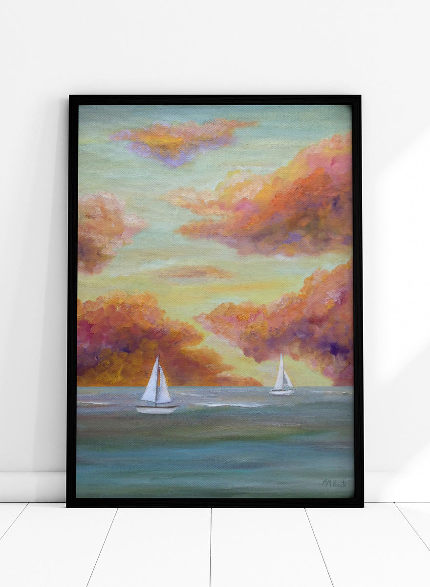 A framed painting of two white sailboats on a calm blue-green sea under a sky filled with soft, painterly clouds in pink, orange, yellow, and purple tones. Shop Sailboat Sunset Sky by Angeles M. Pomata, a coastal landscape art print featuring sailboats, calm water, and a glowing sunset sky.