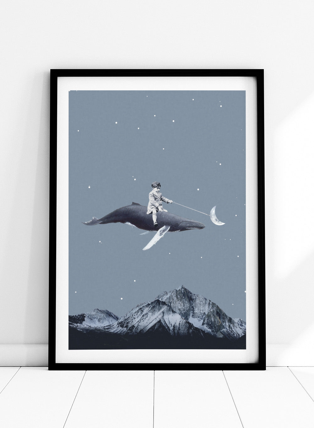 Aim for the Moon by Maarten Léon is a surreal collage art print featuring a boy riding a whale in a starry sky with mountains and moon imagery.