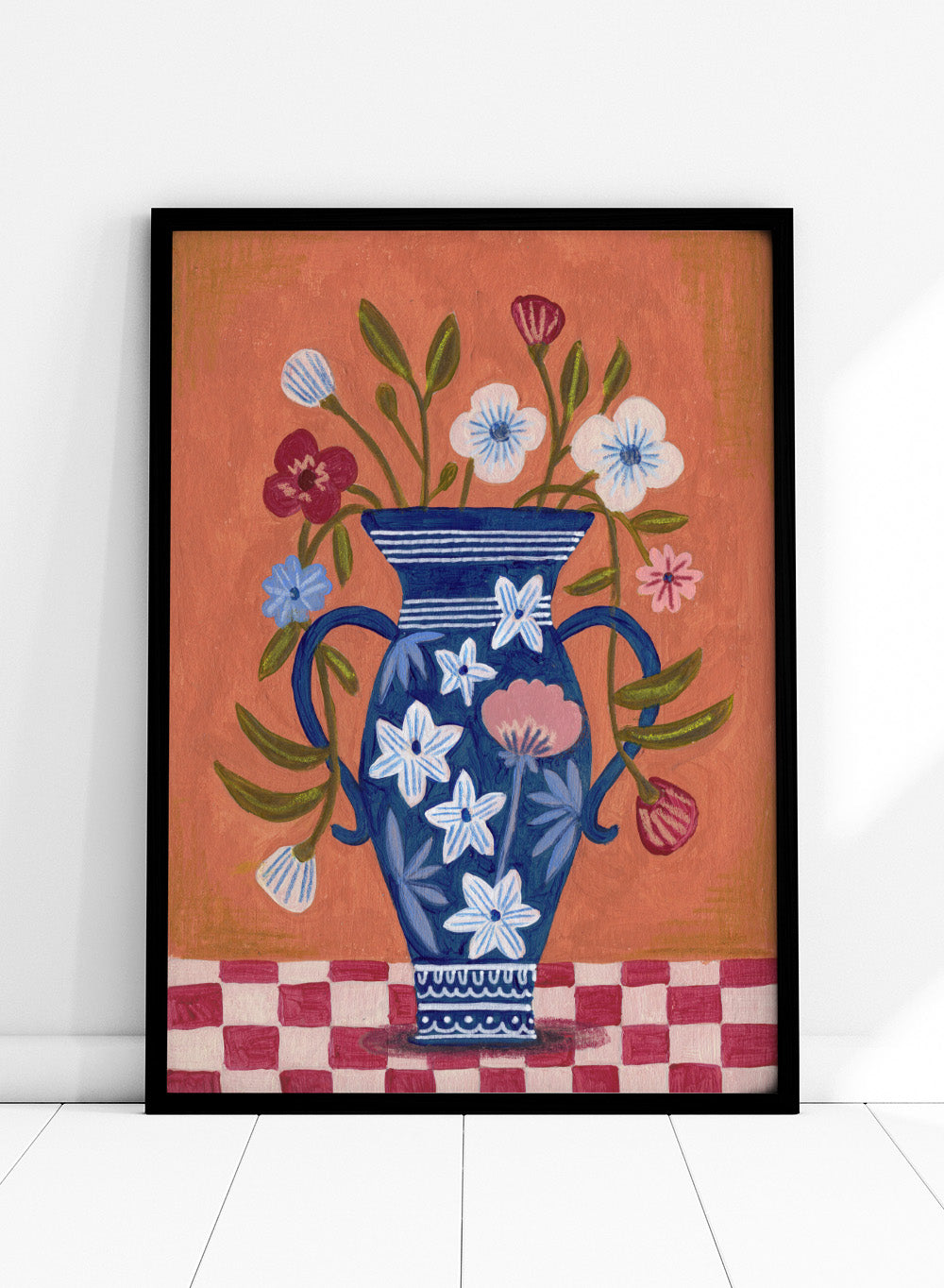 Decorative painting of a blue vase with floral patterns on a checkered floor against an orange wall. Folk Art Flower Vase by Caroline Bonne Müller is a fine art print and wall poster featuring a blue floral vase with colorful flowers on a checkered table.