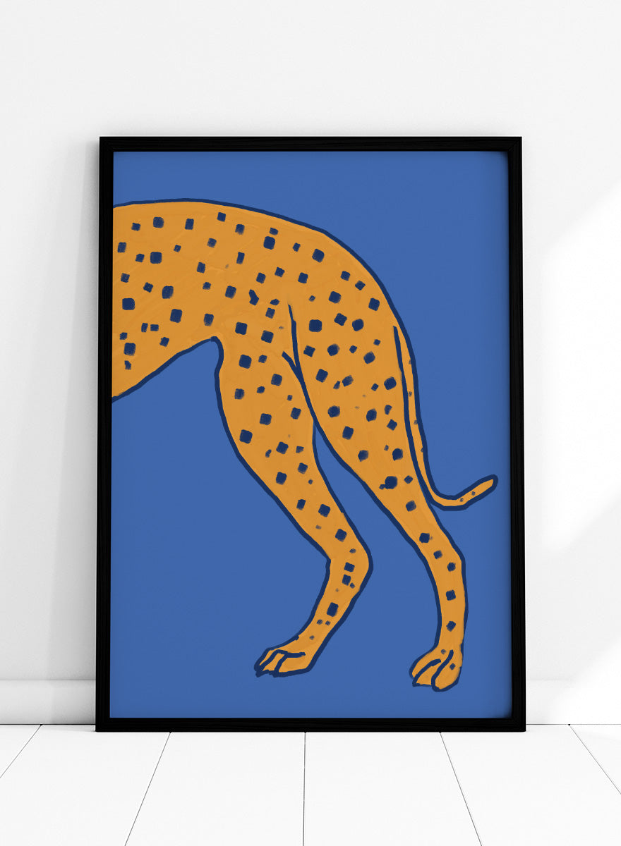 A stylized illustration of a spotted big cat, cropped to show the torso and hind legs, in orange with dark blue spots on a solid blue background. Spotted Cheetah on Blue by The Art Concept animal art print featuring a cropped golden cheetah with deep blue spots against a bold blue background.