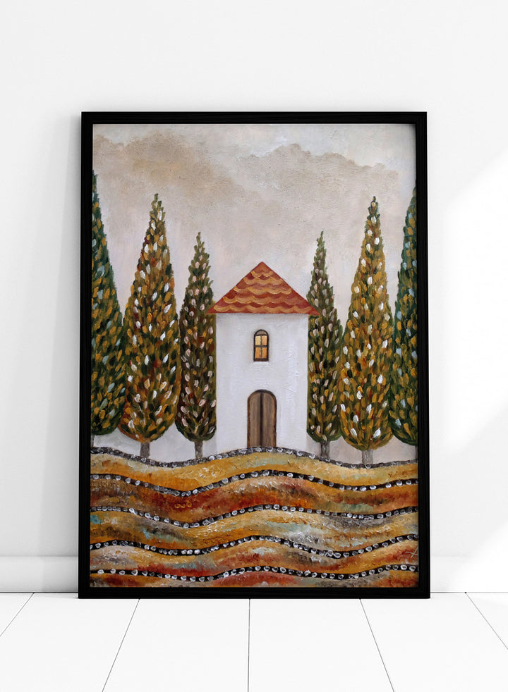 A stylized landscape painting of a small white house with a red-orange tiled roof, surrounded by tall green and gold trees, with wavy golden fields in the foreground. Shop Tuscan Cypress House by Angeles M. Pomata, an autumn landscape art print featuring a white country house, tall cypress trees, terracotta roof, and warm earthy tones.