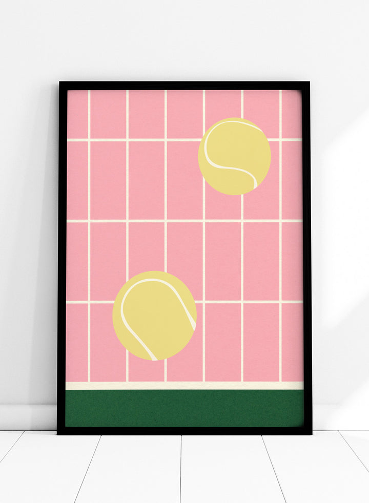 Two yellow tennis balls on a pink grid background with a green stripe at the bottom. Tennis Kitchen by Rosi Feist is a modern minimalist fine art print featuring oversized tennis balls on pink tile. Officially licensed wall poster with optional artisan framing.