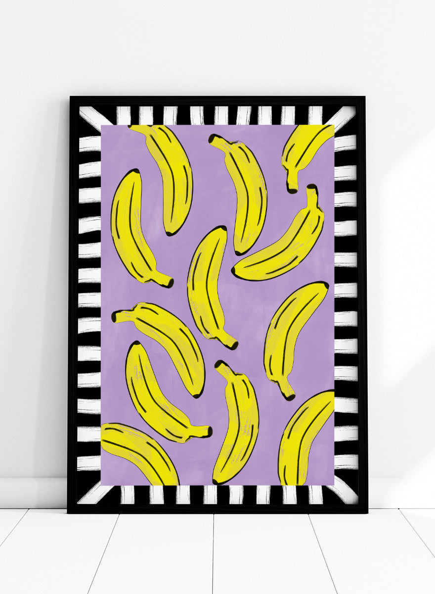 Shop Playful Banana Scatter by Elena Ristova, a banana wall art print poster in yellow, purple, black, and white with a bold striped border.