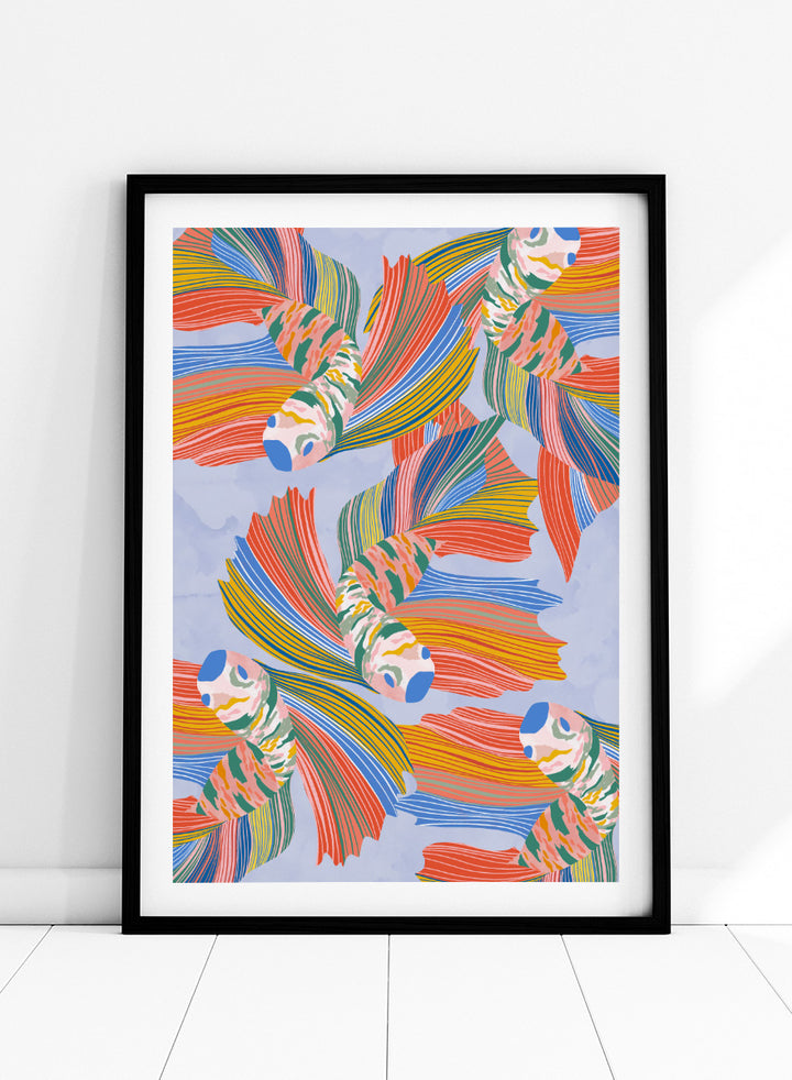 A framed art print featuring a colorful pattern of stylized fish with flowing striped fins in orange, yellow, green, blue, and red on a light blue background. Vibrant Swirling Fish Pattern by Ceyda Alasar art print featuring colorful flowing fish, striped fins, and playful aquatic movement on a soft blue background.