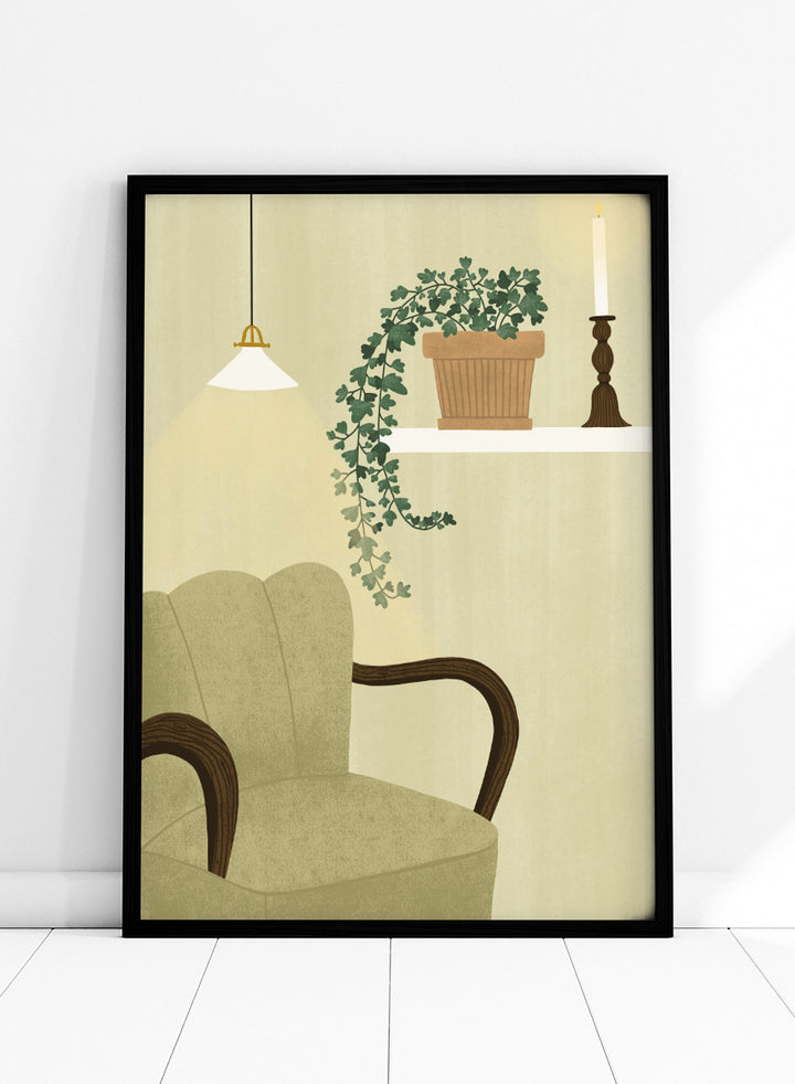 A framed art print featuring a cozy interior scene with a beige armchair, a hanging pendant light, a shelf with a potted trailing green plant and a candlestick, and a cream-colored wall background. Shop Cozy Indoor Retreat by Elsa Nätterdal, a modern interior art print featuring a cozy armchair, trailing houseplant, candlelight, and warm neutral tones.