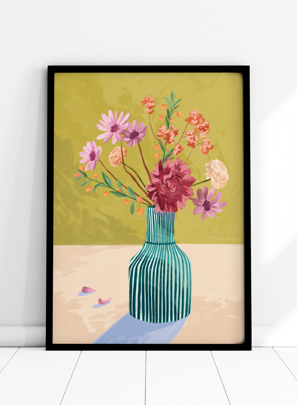 Vase with flowers on a table against a green background. Wildflowers by Goed Blauw is a colorful floral art print and wall poster featuring a striped vase with loose flowers on a warm yellow background.