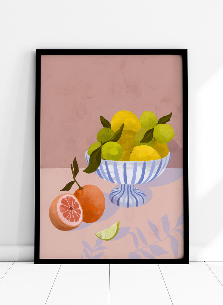 Illustration of a bowl with lemons and limes on a pink background. Bittersweet by Goed Blauw is a still life art print and wall poster with lemons, limes, and grapefruit in a striped bowl on a soft pink background.
