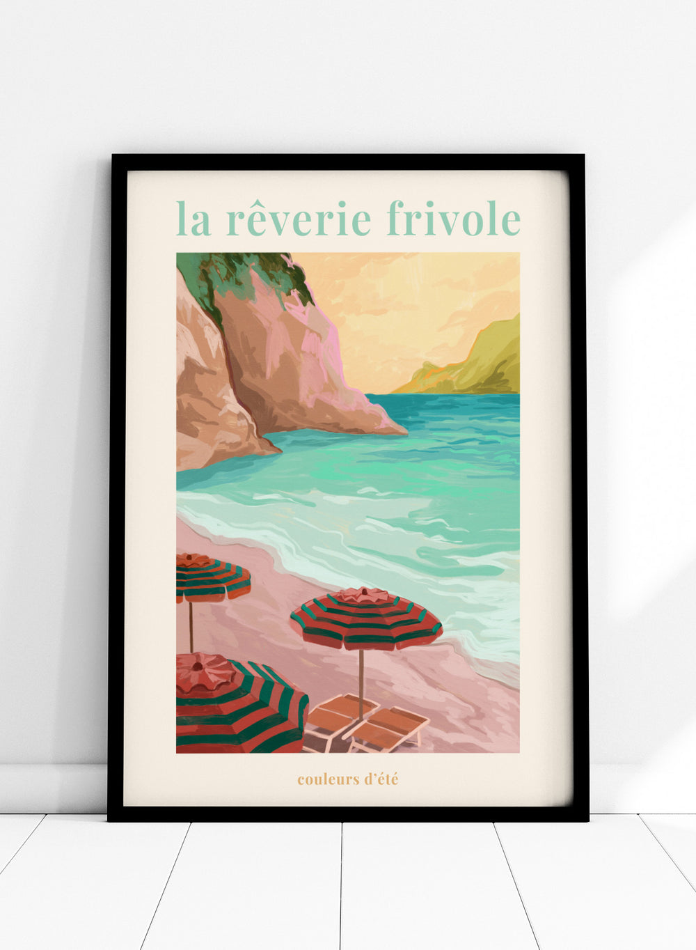 Beach scene with striped umbrellas and cliffs, featuring the text 'la reverie frivole'. La Rêverie Frivole Beach by Goed Blauw is a coastal art print and wall poster featuring striped umbrellas, turquoise water, and a warm seaside landscape.