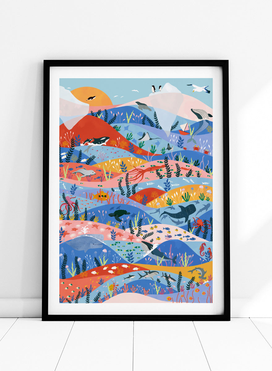 A colorful illustrated art print featuring stylized mountains, sea life, and coastal scenery in layered wavy bands of blue, pink, orange, yellow, and green. Vibrant Ocean Life by Ceyda Alasar ocean art print featuring whales, sharks, rays, turtles, coral reefs, sea plants, and colorful marine life.