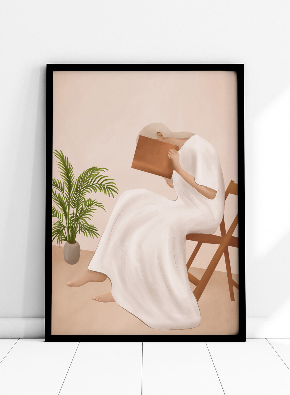 Person in a white dress holding a book, sitting on a chair with a plant nearby. Serene Woman Reading by City Art is a minimalist figurative art print featuring a woman reading in a flowing white dress with warm neutral tones and botanical details.