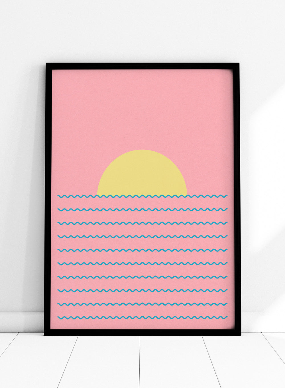 Simplified illustration of a sunset over water with blue waves on a pink background. Every Day the Sun Rises by Rosi Feist is a minimalist sun and waves art print with pink sky. Officially licensed modern poster with framing.