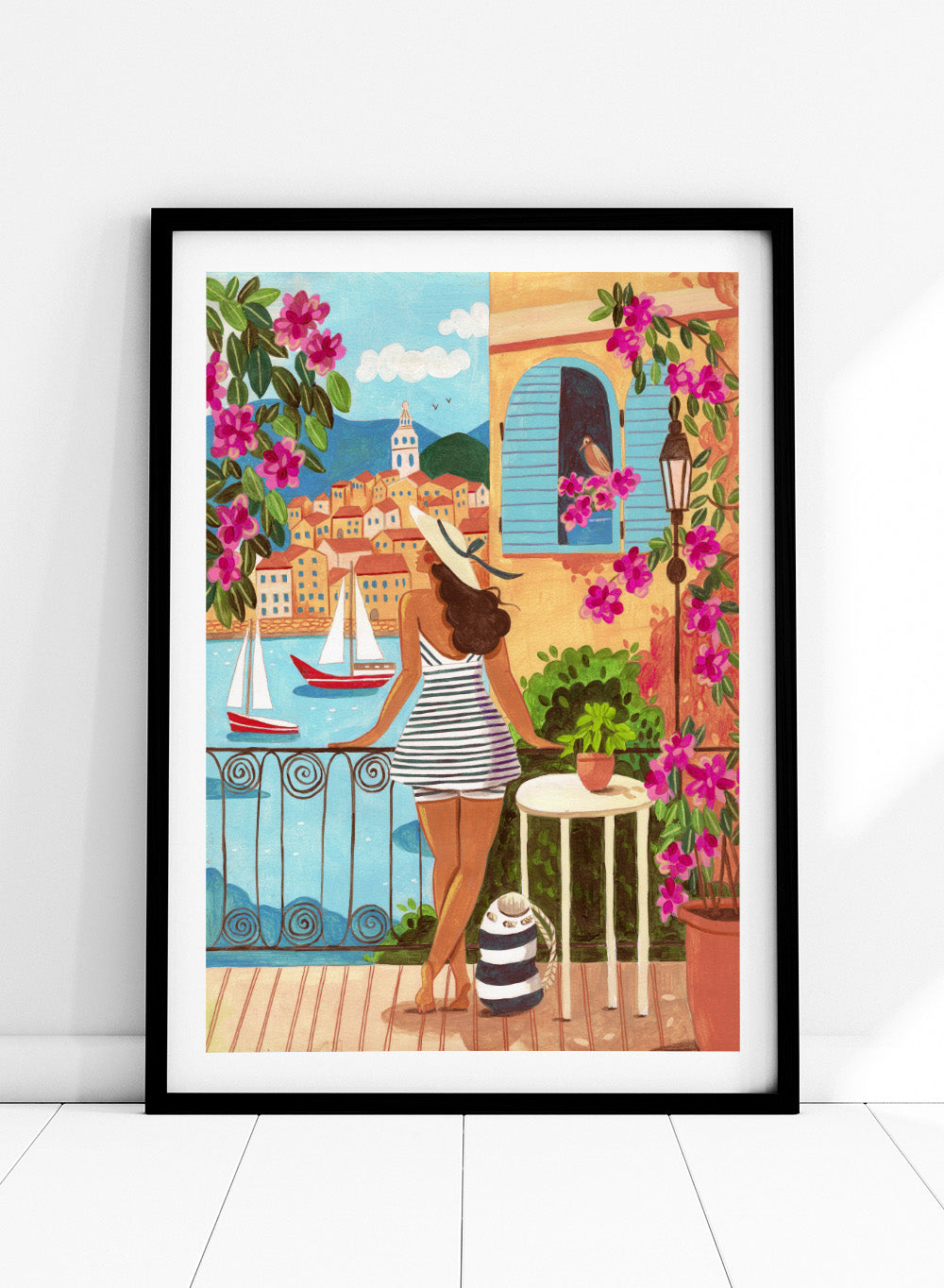 Woman on a balcony overlooking a coastal town with boats and flowers. Woman Balcony Coastal View by Caroline Bonne Müller is a fine art print and wall poster of a woman overlooking a coastal town with boats in a modern aesthetic style.