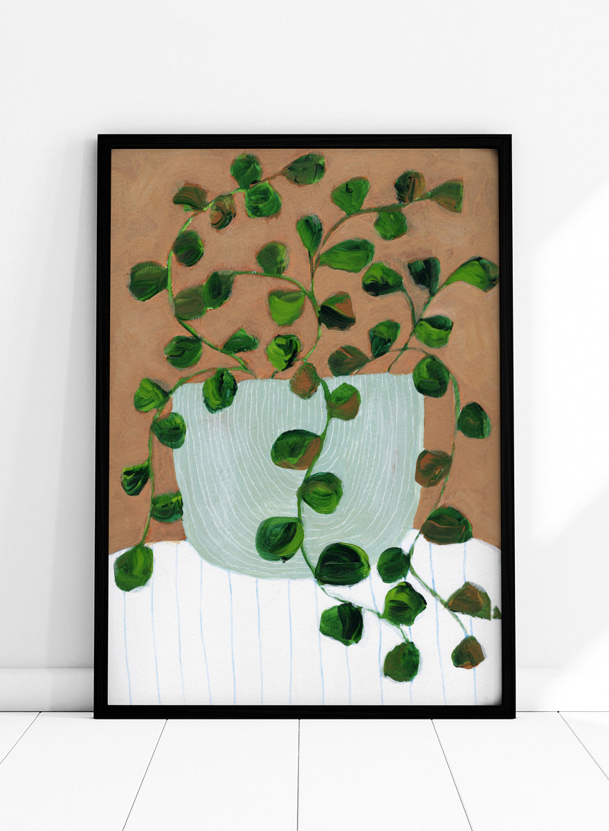 Shop Warm Houseplant Pot by Nikita Jariwala, a botanical wall art print poster featuring a trailing houseplant in a green pot with warm green tones.