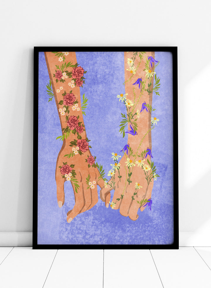 Illustration of two hands holding each other with floral designs on a blue background. Holding Hands by Raissa Oltmanns is a modern romantic fine art print featuring floral arms illustration and contemporary love wall decor poster.