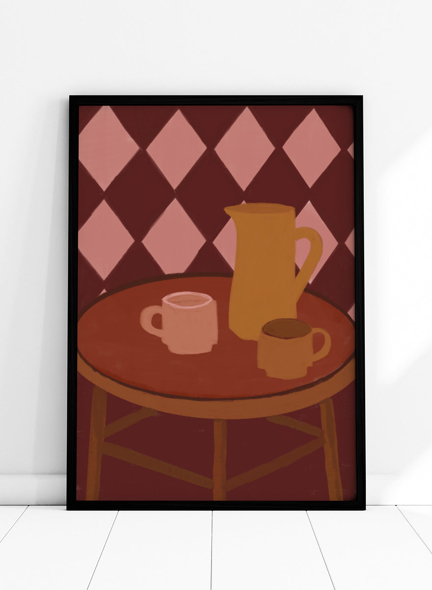 A stylized illustration of a round wooden table with a pink mug, a yellow pitcher, and a small cup against a dark red and pink diamond-patterned background. Retro Coffee Time by The Art Concept warm art print featuring mugs, a pitcher, and a café table in soft retro tones and a diamond pattern background.