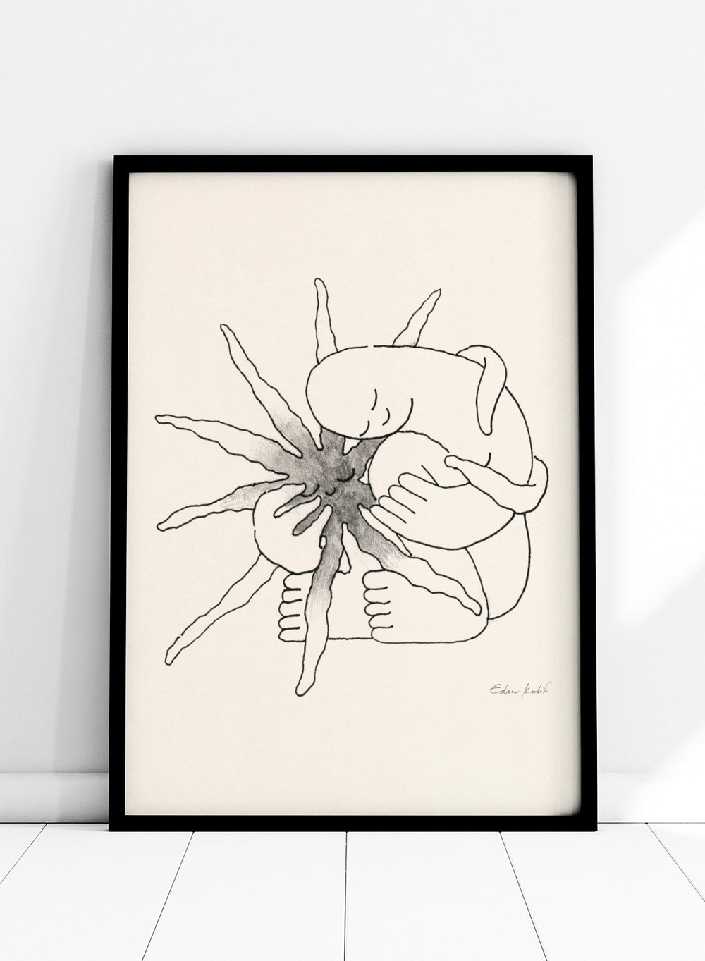 Black and white line art of a person embracing a sun figure on a beige background. Sunshine Love by Eden Kalif is a modern line art print featuring a figure holding a sun in a minimalist contemporary wall poster design.