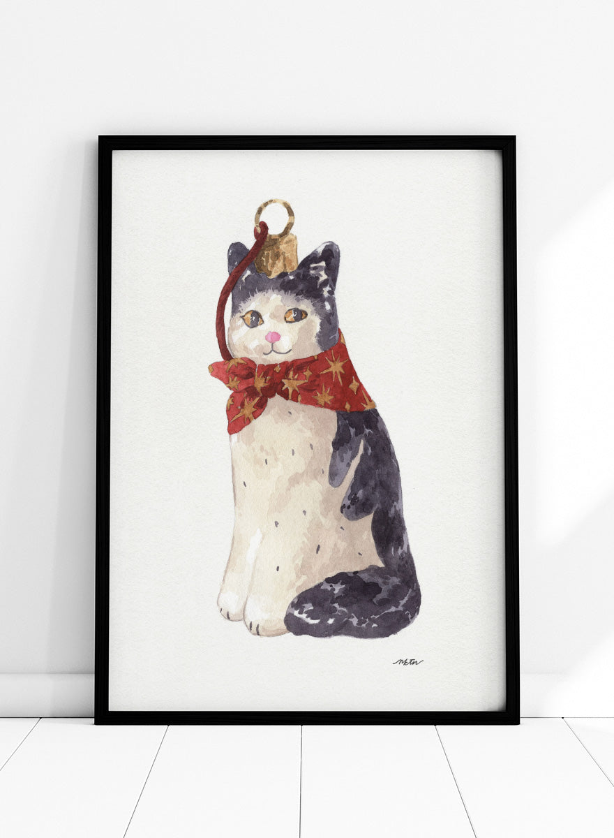 Shop Christmas Cat Ornament by NKTN, a festive cat animal wall art print poster featuring a black-and-white cat in a red star scarf with watercolor detail.