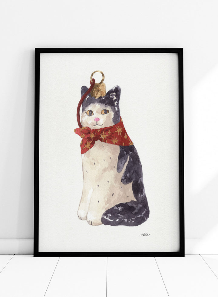 Shop Christmas Cat Ornament by NKTN, a festive cat animal wall art print poster featuring a black-and-white cat in a red star scarf with watercolor detail.