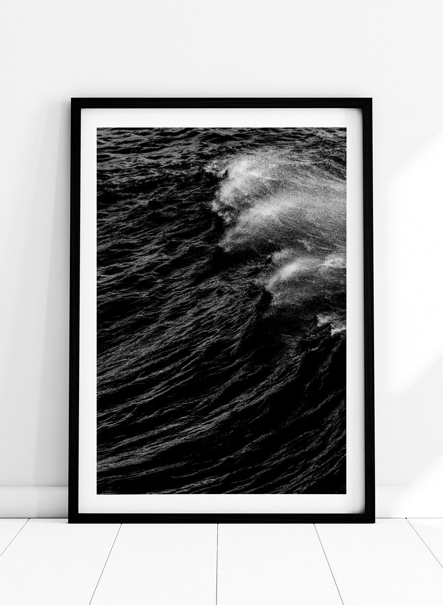 Black and white fine art photographic print of a crashing ocean wave. Dark Wave Symphony by Shot by Clint black-and-white ocean photography print featuring breaking waves, sea spray, and dramatic water texture.