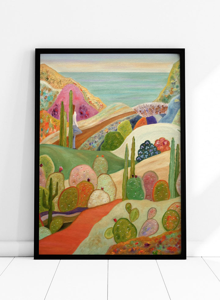 A colorful landscape painting featuring stylized cacti and succulents in a desert valley, with rolling hills, a pink mountain, and a blue sea or sky in the background. Shop Colorful Desert Yoga View by Angeles M. Pomata, a colorful desert landscape art print featuring cacti, rolling hills, a yoga figure, and coastal views.