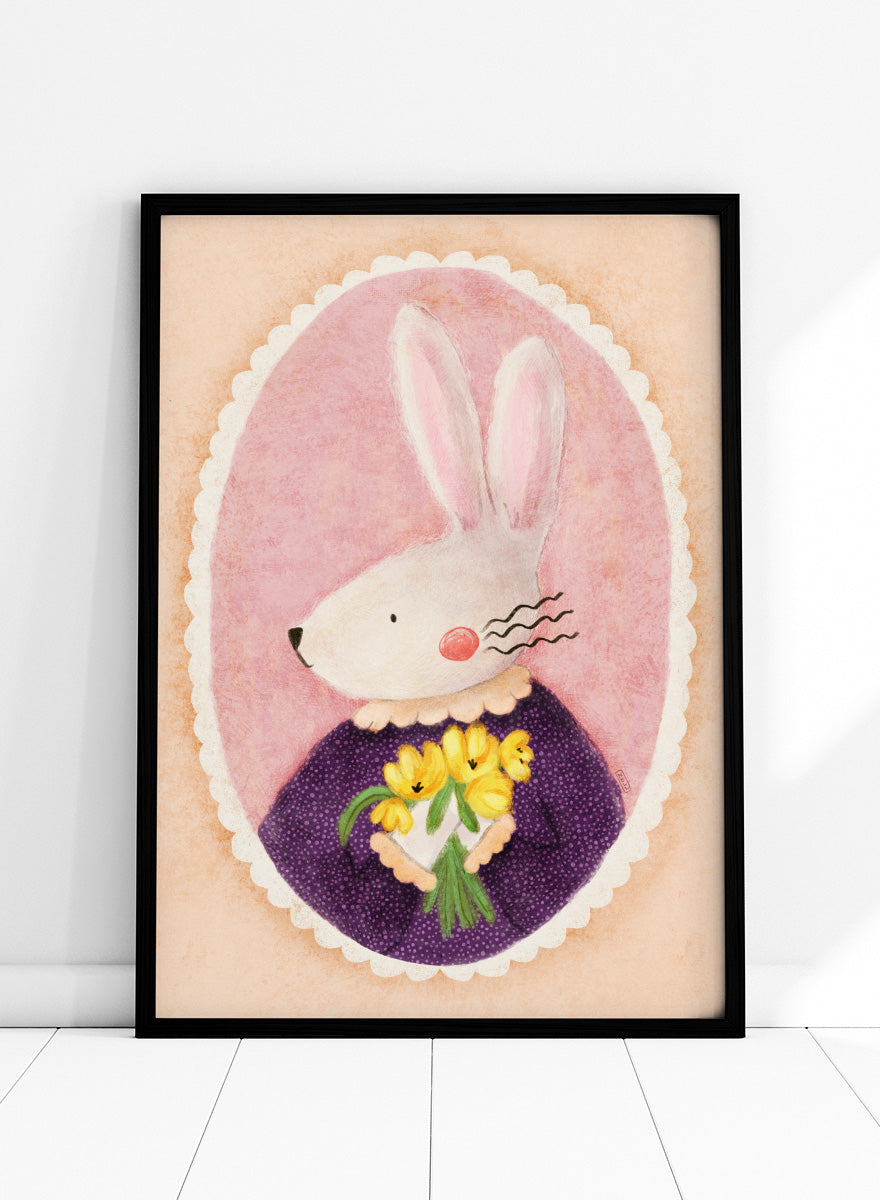 A framed art print featuring a whimsical illustration of a white rabbit in a purple dress holding yellow flowers, set against a pink oval background. Shop Charming Bunny With Tulips by Dirkie Nell, a playful animal portrait art print featuring a white bunny, yellow tulips, purple dress, and soft pink tones.