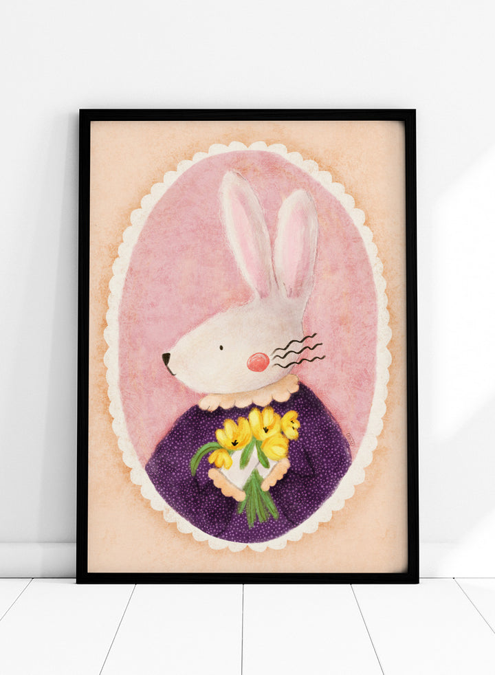 A framed art print featuring a whimsical illustration of a white rabbit in a purple dress holding yellow flowers, set against a pink oval background. Shop Charming Bunny With Tulips by Dirkie Nell, a playful animal portrait art print featuring a white bunny, yellow tulips, purple dress, and soft pink tones.