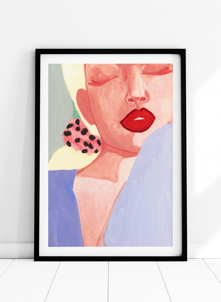 Shop Red Lips by Sophia Novosel, a modern woman portrait wall art print poster featuring bold red lips, closed eyes, soft pink tones, and a spotted earring.