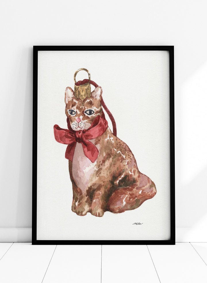 Shop Charming Cat Ornament by NKTN, a festive cat wall art print poster featuring a brown tabby with an oversized red bow and watercolor holiday style.