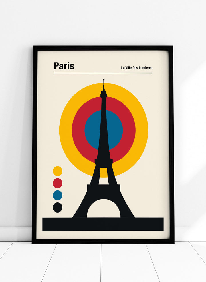 A minimalist Paris poster featuring a black Eiffel Tower silhouette in front of concentric yellow, red, and blue circles on a cream background, with the text &