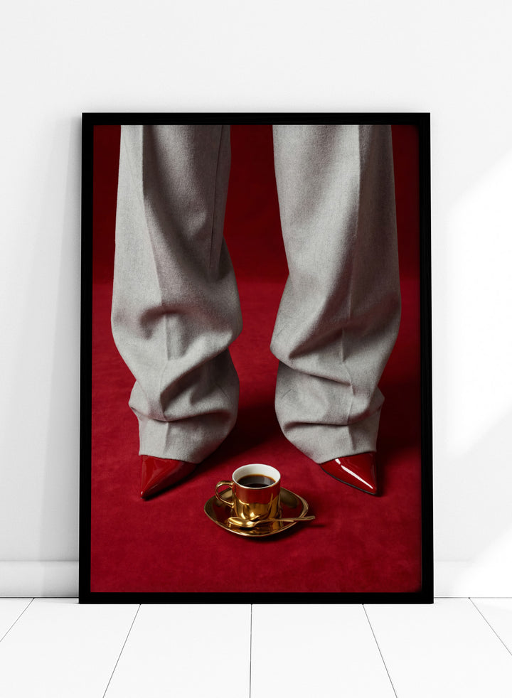 White pants with red shoes on a red carpet, featuring a gold cup and saucer with coffee. Red Shoes and Coffee by Andreas Magnusson is a fashion photography art print featuring red heels and espresso. Officially licensed modern wall poster.