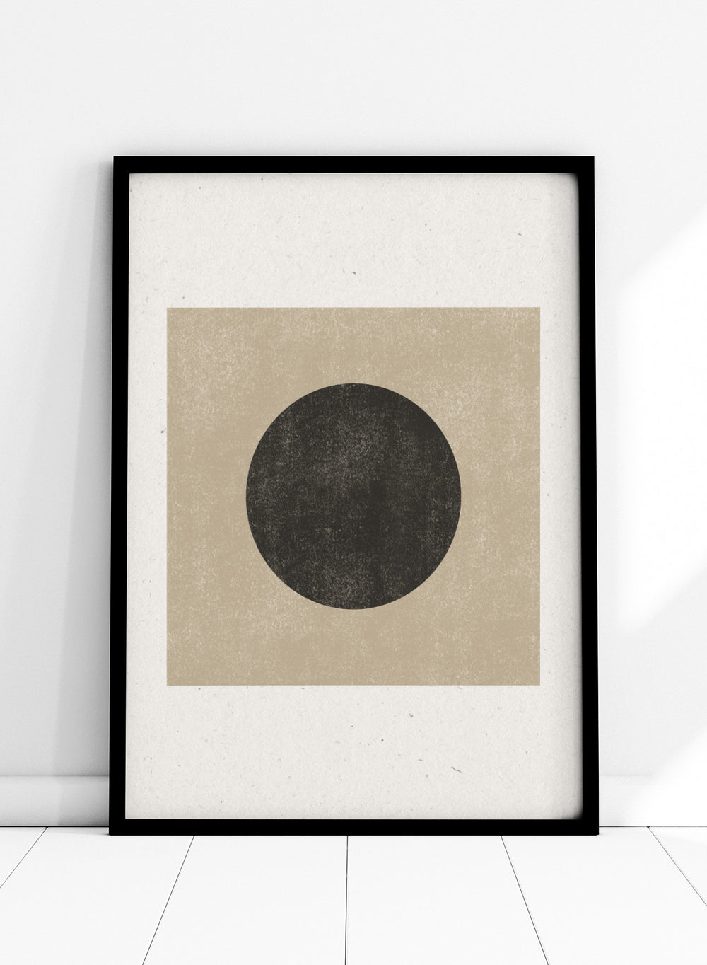 Black circle on beige background. Eclipse Silence by The MIUUS Studio is a minimalist abstract art print and wall poster featuring geometric shapes, neutral tones, and modern textured design.