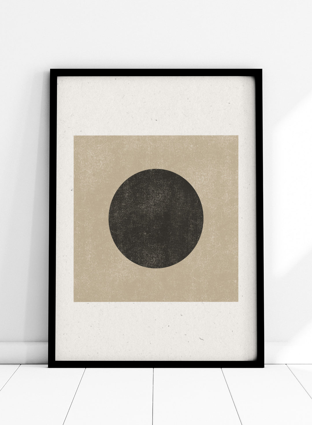 Black circle on beige background. Eclipse Silence by The MIUUS Studio is a minimalist abstract art print and wall poster featuring geometric shapes, neutral tones, and modern textured design.