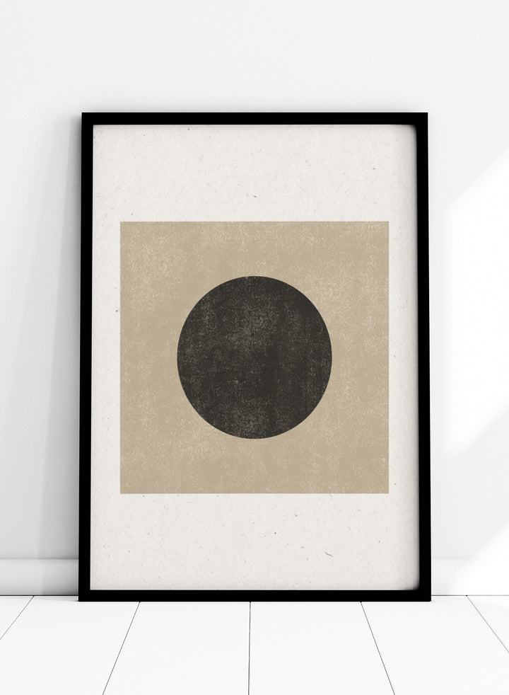 Black circle on beige background. Eclipse Silence by The MIUUS Studio is a minimalist abstract art print and wall poster featuring geometric shapes, neutral tones, and modern textured design.