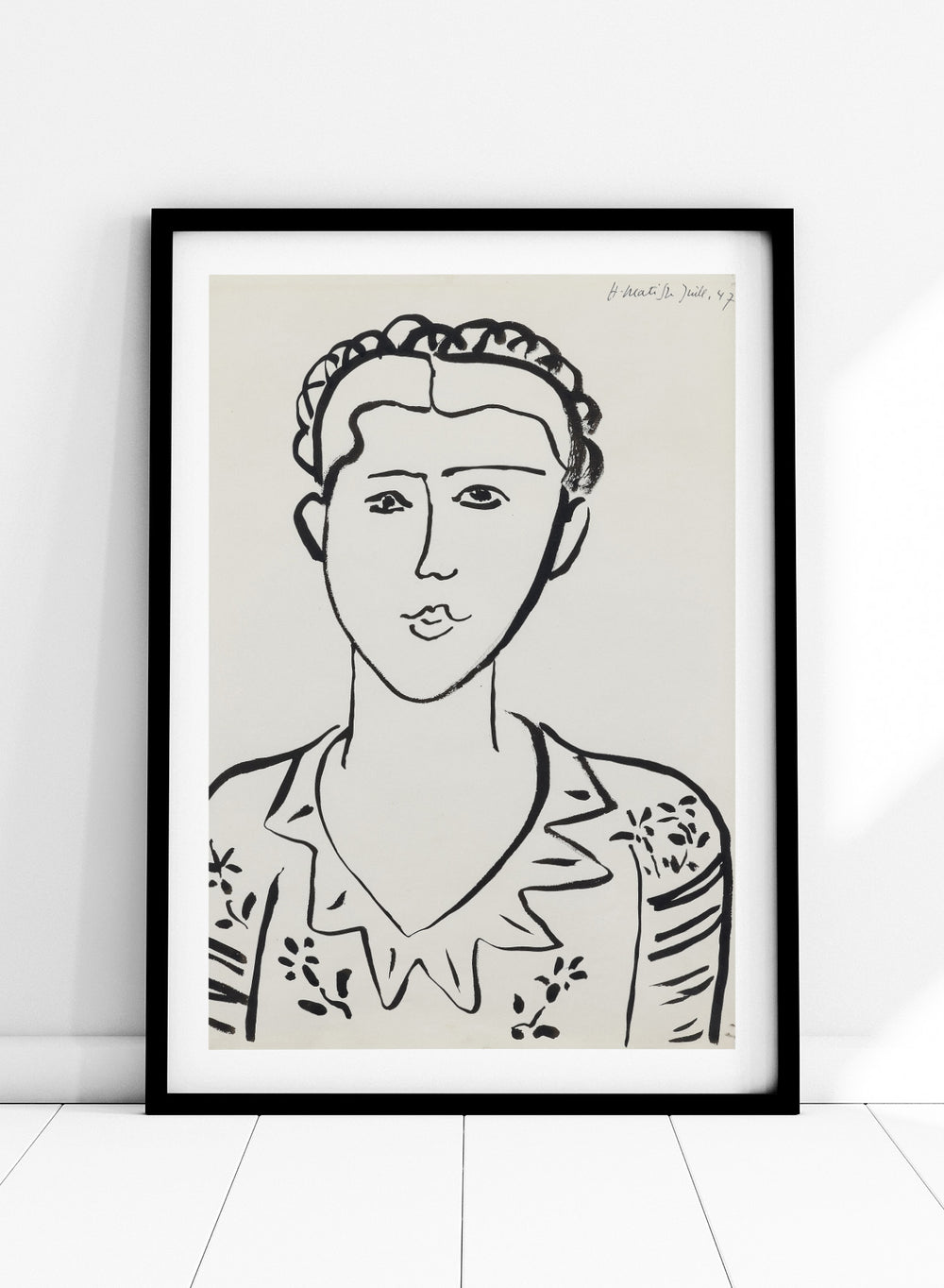 Black line drawing of a woman's portrait on a white background. Portrait de femme by Henri Matisse is a minimalist portrait art print featuring expressive black linework, modern French design, and iconic mid century style.