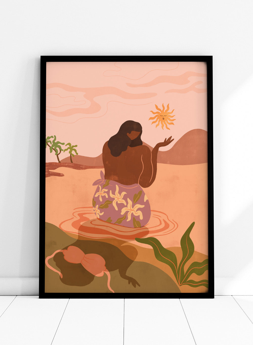 Illustration of a woman in a floral dress sitting by a pool with a sun and desert landscape in the background. Sunset by Arty Guava art print, modern woman illustration wall poster in warm pink tones, contemporary nature landscape artwork.