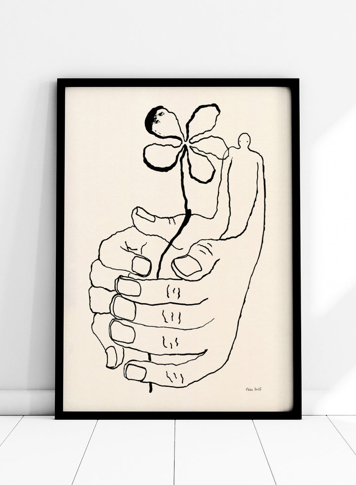 Black line drawing of a hand holding a flower on a beige background. Let It Grow by Eden Kalif is a modern line art print featuring a hand holding a flower with a human figure, designed as a minimalist contemporary wall poster.