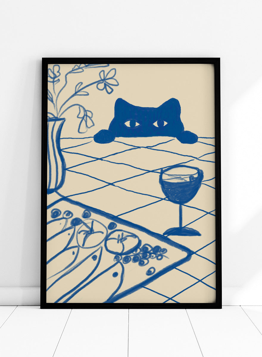 A stylized blue line-art illustration of a cat peeking over a table with a wine glass, flowers, and food, rendered in a cream background. Curious Blue Cat Dinner by The Art Concept is a playful cat art print featuring a peeking blue cat, table setting, flowers, and bold linework.
