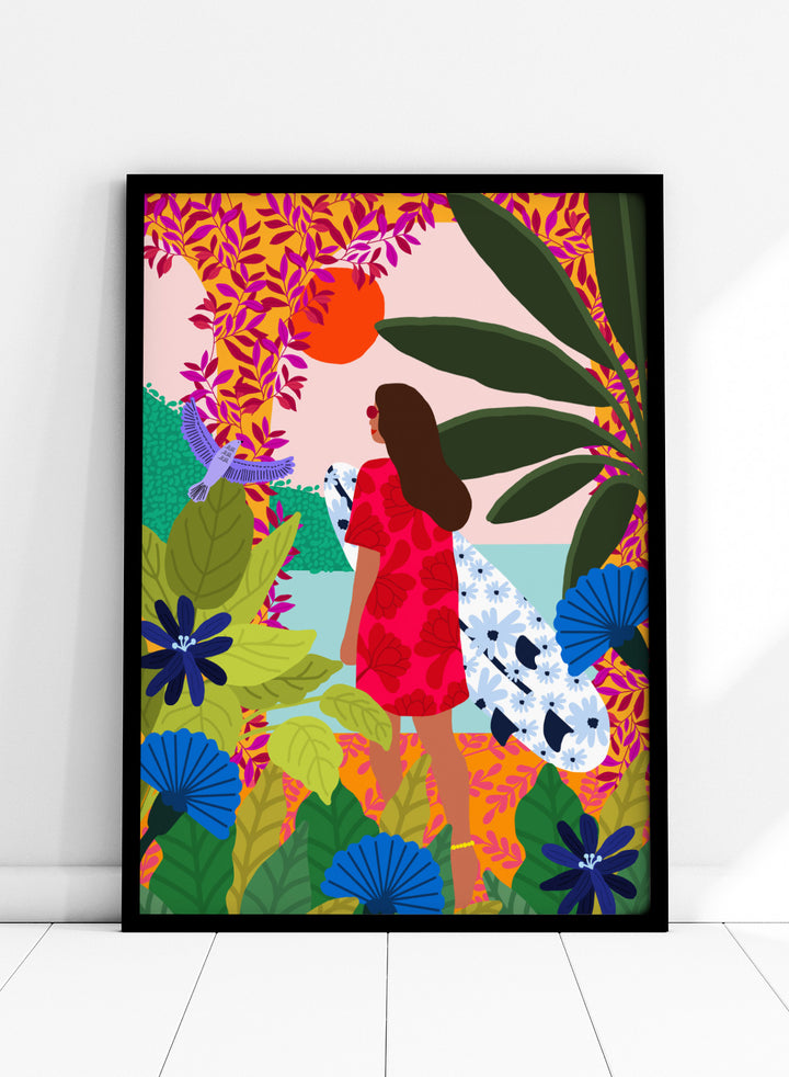 Woman in a red dress with a white surfboard amidst tropical foliage and flowers. Going Surfing by Rafaela Mascaro is a colorful tropical art print featuring a surfer, lush botanicals, vibrant florals, and sunny coastal inspiration.
