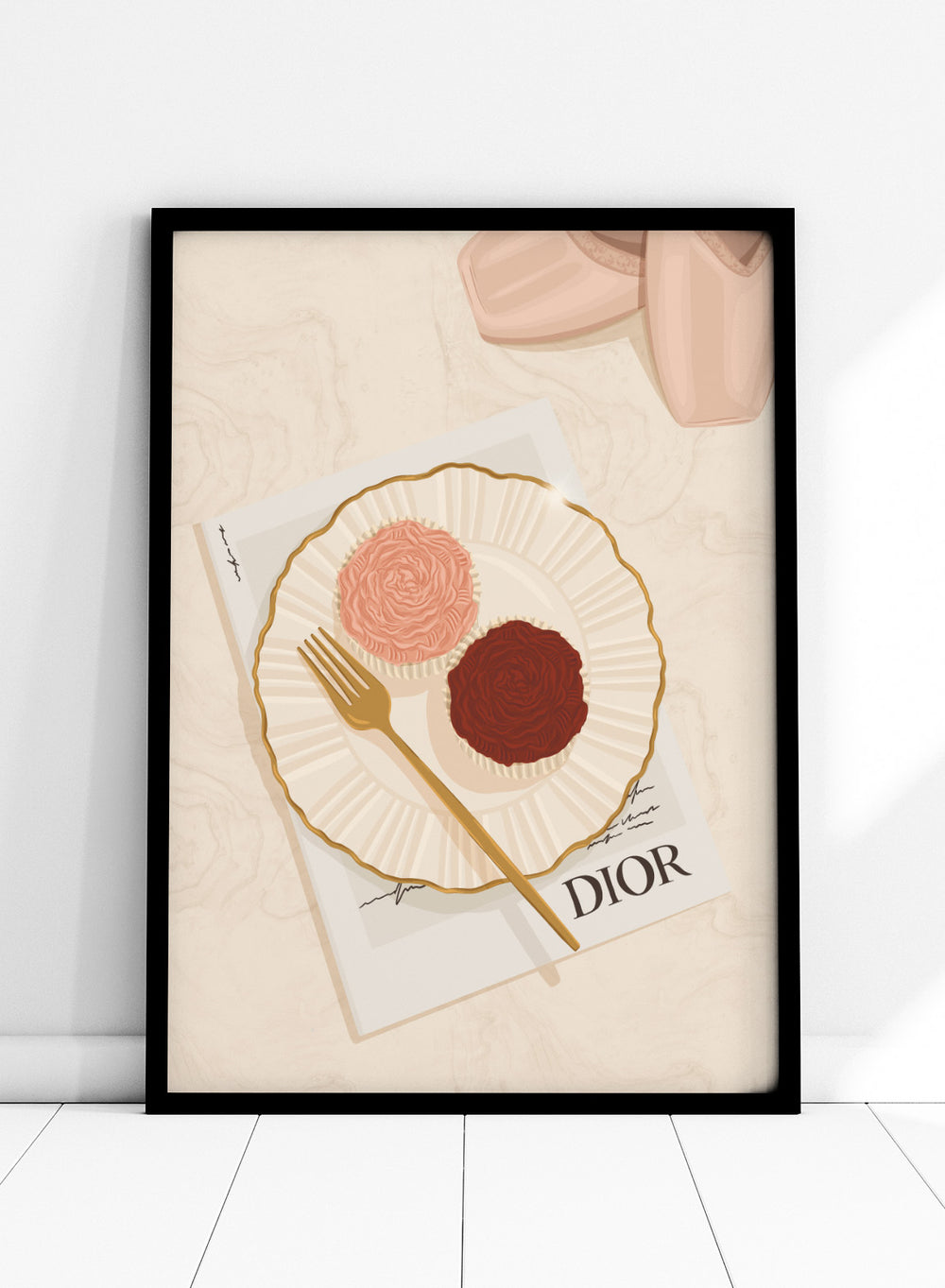 A stylized flat-lay illustration featuring a white plate with a gold rim holding two rose-shaped pastries, one light pink and one dark chocolate brown, with a gold fork on top. Elegant Cupcakes Ballet Shoes by Lisa Solomoniuk premium framed fine art print featuring pink ballet shoes, frosted cupcakes, and gold details.