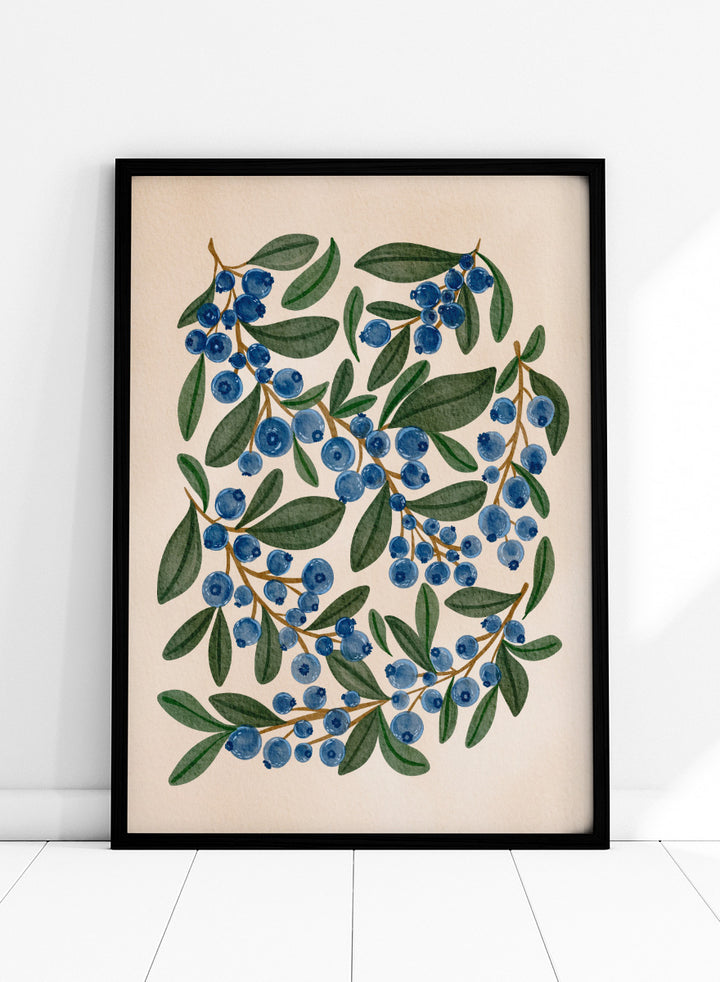 Botanical art print of blueberry branches with green leaves on a warm beige background. Shop Fresh Blueberry Sprigs by Nikita Jariwala, a botanical wall art print poster featuring blueberry branches, deep blue berries, and leafy green summer detail.