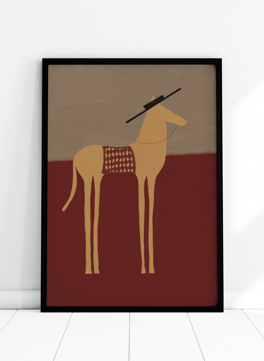 A stylized art print of a camel standing in profile, with a dark hat on its head and a patterned saddle blanket, set against a split beige and dark red background. Desert Horse with Sombrero by The Art Concept animal art print featuring a long-legged horse, patterned saddle blanket, black sombrero, and warm desert tones.