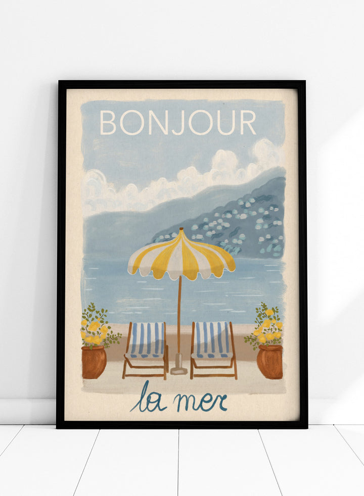 A vintage-style illustrated poster or print showing a beach scene with two striped lounge chairs under a yellow-and-white umbrella, potted plants, blue water, and mountains in the background. The words &