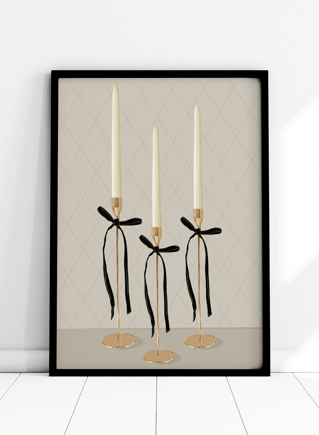 Three gold taper candle holders with cream candles and black ribbon bows, arranged on a light gray surface against a beige diamond-patterned background. Elegant Gold Taper Candles by Lisa Solomoniuk premium framed fine art print featuring gold candlesticks, cream tapers, and long black ribbons.