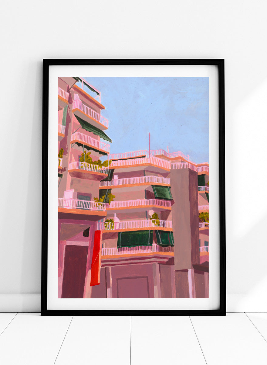 Shop Pink City Balconies by Sophia Novosel, a colorful city wall art print poster featuring pink apartment buildings, green awnings, balconies, and blue sky.