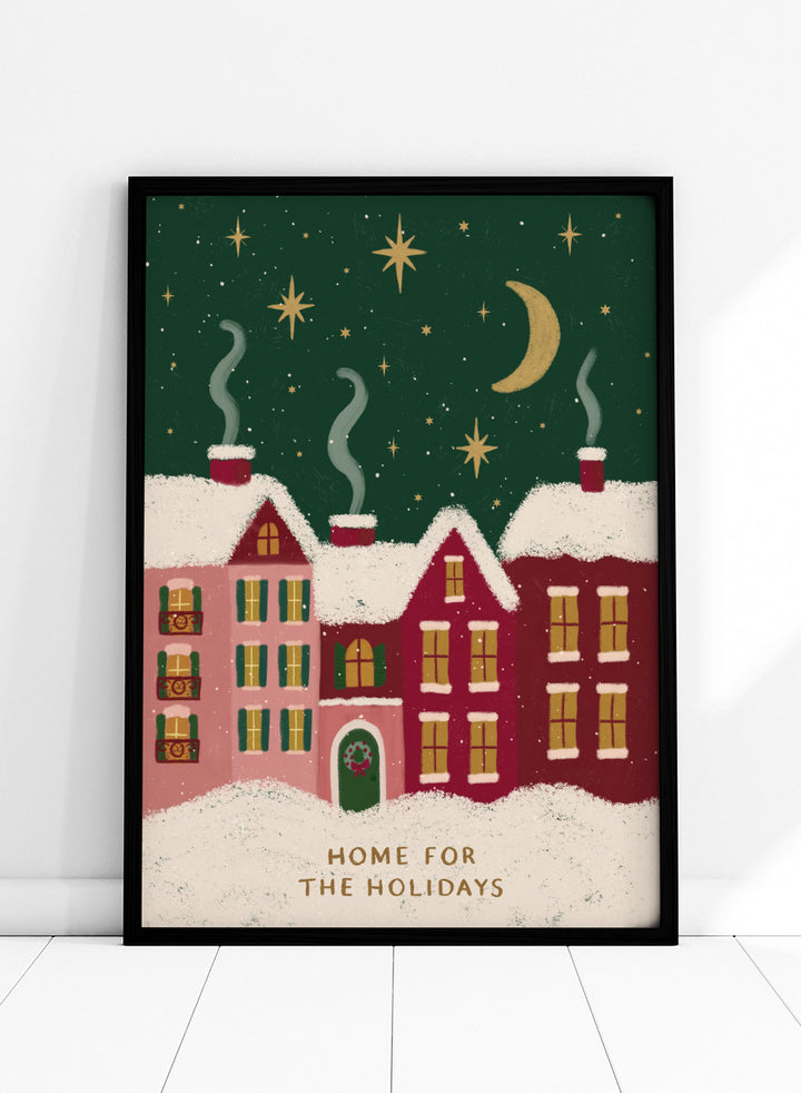 Shop Home For The Holidays by Katarzyna Gąsiorowska, a Christmas wall art print poster featuring snowy houses, glowing windows, stars, and a cozy winter village scene.