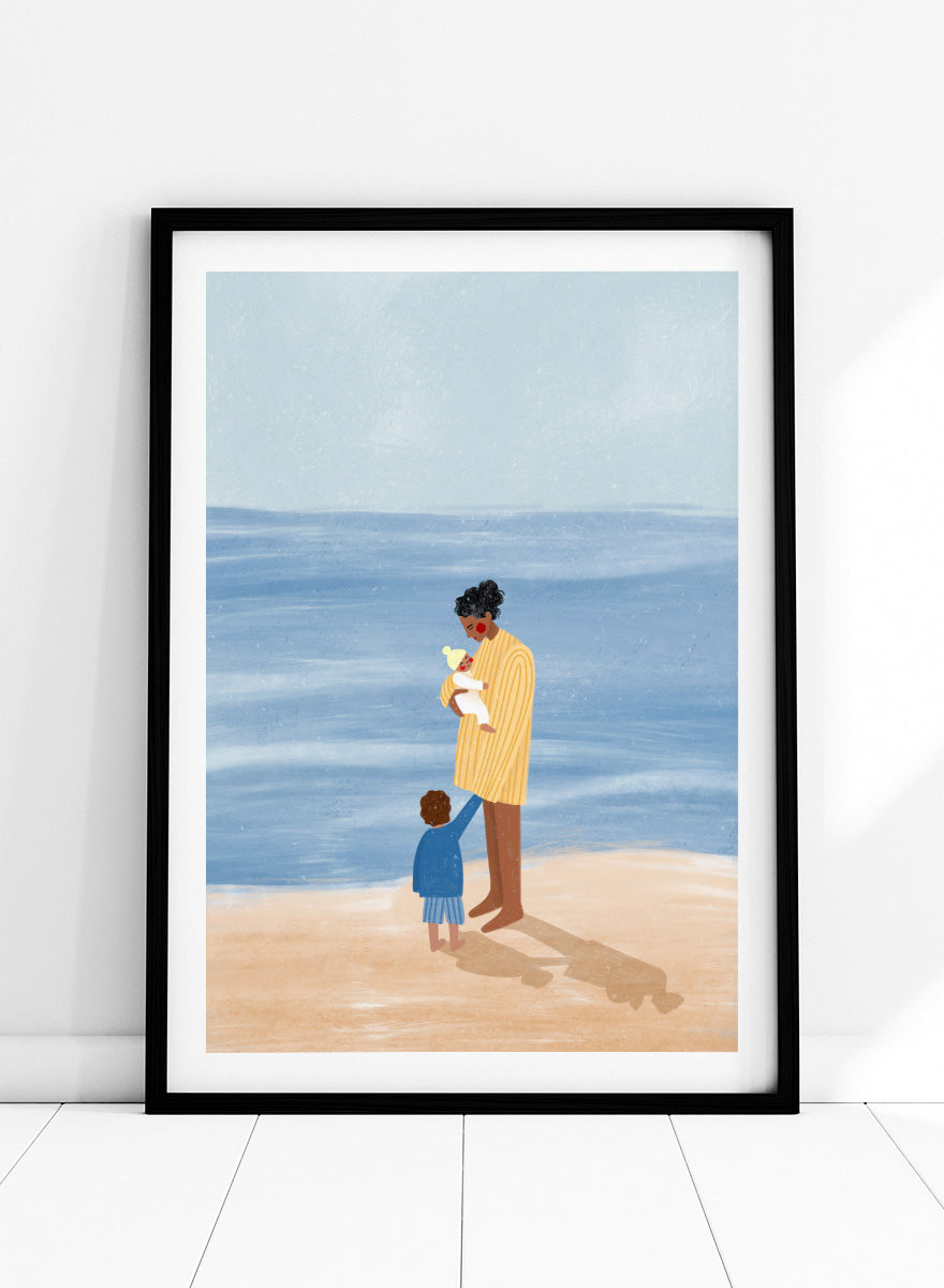 A framed art print featuring an illustration of a man in a yellow striped shirt holding a white dog on a beach next to a child in a blue coat, set against a light blue ocean and pale sky. Family Beach Day by Bea Müller art print featuring a mother with her baby and young child by the sea, created for warm family and coastal decor.